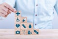 Hand chooses a emoticon icons healthcare medical symbol on wooden block , Healthcare and medical Insurance concept Royalty Free Stock Photo