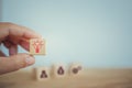 Hand chooses wooden cube block symbol and light bulb icon