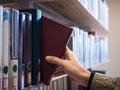 Hand choosing Book from Book shelf Library Education Royalty Free Stock Photo