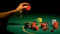 Hand choosing chip on poker table, gambler worrying, afraid to lose all-in bet