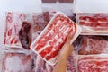 Hand choosing fresh raw yakiniku meat in freezer Royalty Free Stock Photo