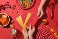 A hand is choosing a red envelope among many other lucky money envelopes. On the table, a plate of jam, tangerines, red fireworks Royalty Free Stock Photo