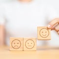 Hand choosing smile face from Emotion block for customer review, good experience, positive feedback, satisfaction, survey, Royalty Free Stock Photo