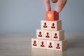 Hand choosing wood cube with icon light bulb and human symbol,creative idea and innovation concept Royalty Free Stock Photo