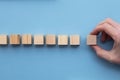 Hand choosing a wooden block from a set. Business choice concept Royalty Free Stock Photo