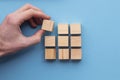 Hand choosing a wooden block from a set. Business choice concept Royalty Free Stock Photo