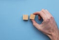 Hand choosing a wooden block from a set. Business choice concept Royalty Free Stock Photo