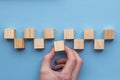 Hand choosing a wooden block from a set. Business choice concept Royalty Free Stock Photo