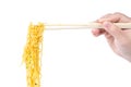 Hand with chopsticks clamp Chinese Wonton noodles, roast pork and vegetable isolated on white background