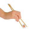 Hand with chopsticks eating maki roll, sushi with rice and salmon, isolated on white Royalty Free Stock Photo