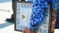 The hand of a civil servant holds the text of Pancasila at a state ceremony.