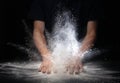 Hand clap and white flour on black background Royalty Free Stock Photo