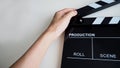 Hand with clapper board or movie slate use in film or video production or movie and cinema industry. It`s black color on white Royalty Free Stock Photo