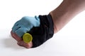 Hand clasped in a glove black in bicycle gloves blue with open fingers holding a green pipe isolated on white background Royalty Free Stock Photo