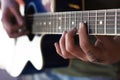 Hand of classical guitar player with fingers at the strings and the neck of the guitar Royalty Free Stock Photo