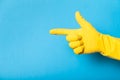 Hand in clean yellow glove, bathroom. Copy space for text Royalty Free Stock Photo