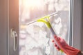 Hand of a cleaner in a rubber glove washes a window Royalty Free Stock Photo