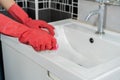 Hand cleaning bathroom sink with brush Royalty Free Stock Photo