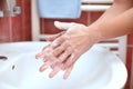 Hand cleaning in bathroom. Soapy hands.