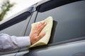 Hand cleaning the car window with microfiber cloth Royalty Free Stock Photo