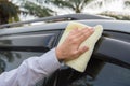 Hand cleaning the car window with microfiber cloth Royalty Free Stock Photo