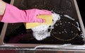 Hand cleaning cooktop. Royalty Free Stock Photo
