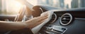 The hand cleaning the dashboard of a modern car in a sunny urban setting. AI generated image Royalty Free Stock Photo