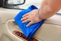 Hand cleaning interior car door panel with microfiber cloth Royalty Free Stock Photo