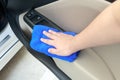 Hand cleaning interior car door panel with microfiber cloth Royalty Free Stock Photo