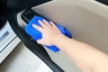 Hand cleaning interior car door panel with microfiber cloth Royalty Free Stock Photo