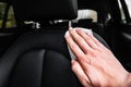 Hand cleaning leather car seat using white wet cloth. Royalty Free Stock Photo