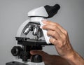 Hand Cleaning Microscope Lens with Cloth in Laboratory Setting Royalty Free Stock Photo