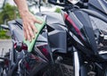 Hand with cleaning motorcycle