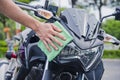 Hand with cleaning motorcycle