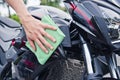 Hand with cleaning motorcycle