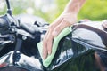 Hand with cleaning motorcycle