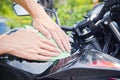 Hand with cleaning motorcycle