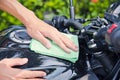 Hand with cleaning motorcycle