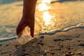 A hand cleaning and picking up a plastic glass trash Royalty Free Stock Photo