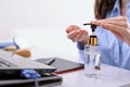 Hand cleaning with sanitizer, cleaning antibacterial gel for hands, remote work on laptop at home concept Royalty Free Stock Photo