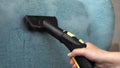 Hand cleaning a sofa with steam cleaner, Home cleaning concept.