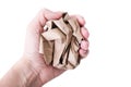 A hand clenched into a fist holding crushed, crumpled sheet of brown craft recycled paper isolated on white, recycling