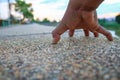 Hand clinging on walkway stone in the public park select focus with shallow depth of field