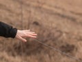 Hand close to wire of electric fence Royalty Free Stock Photo