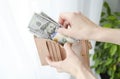 hand close-up hold a black purse in which dollars lie Royalty Free Stock Photo