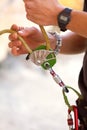 Hand, closeup and rock climbing in safety harness for adventure, hiking or outdoor gear in summer. Hiker, rope knot or