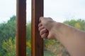 Hand closing the window