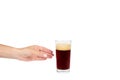 Hand with cold glass of dark beer or kvass with foam isolated on white background, copy space template. Royalty Free Stock Photo