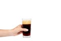 Hand with cold glass of dark beer or kvass with foam isolated on white background, copy space template. Royalty Free Stock Photo