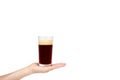 Hand with cold glass of dark beer or kvass with foam isolated on white background, copy space template. Royalty Free Stock Photo